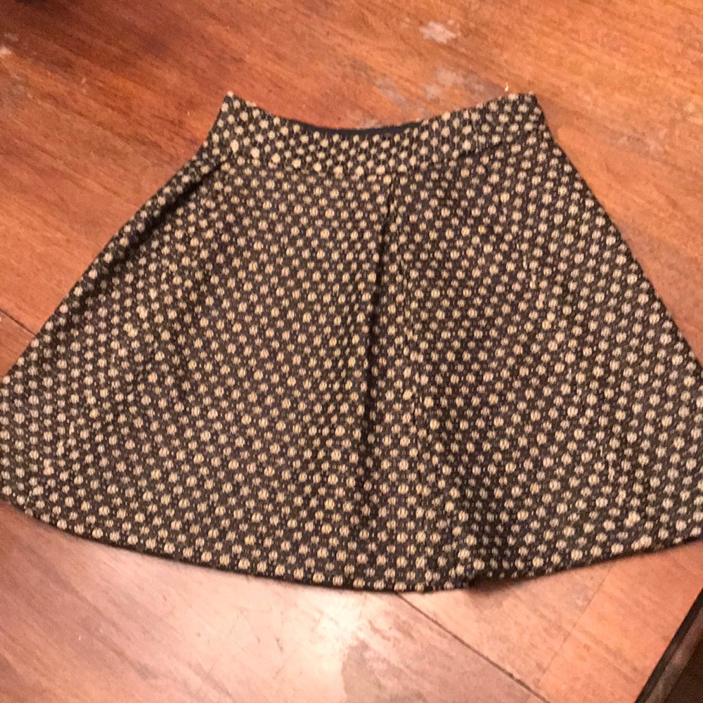 Beige skirt with lace overlay.